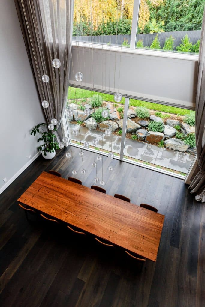 looking down at a dining table inside a custom built home