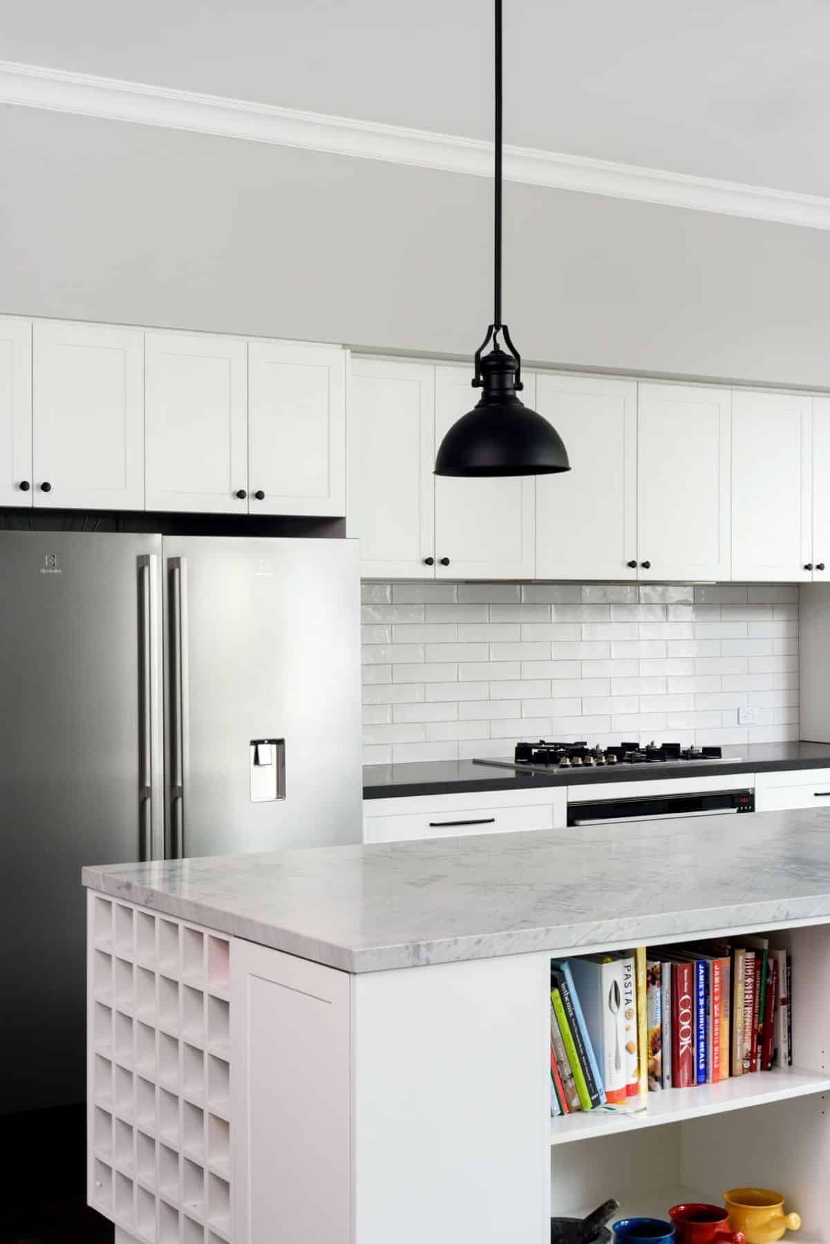 marble island counter with shelves, white and black themed kitchen in a custom home build Nunawading, Nunawading custom homes